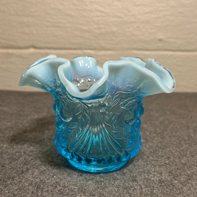 Bright blue glass with a whimsical cherry design. Wreathed/ruffled rim in a light opalescent color.