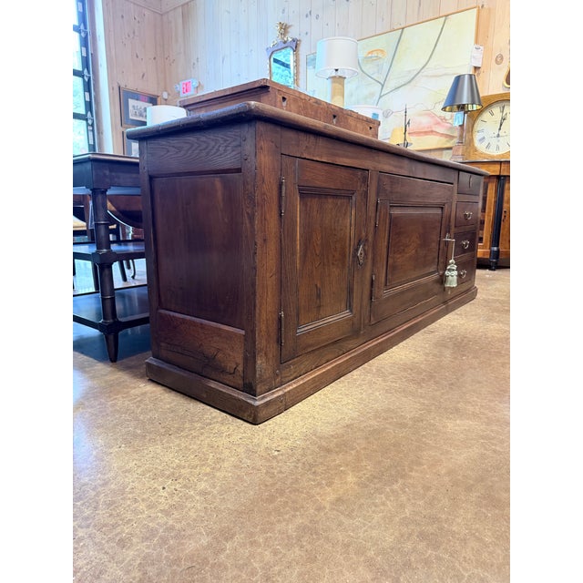 A substantial 19th century primitive oak sideboard showcasing the honest craftsmanship and enduring appeal of early...