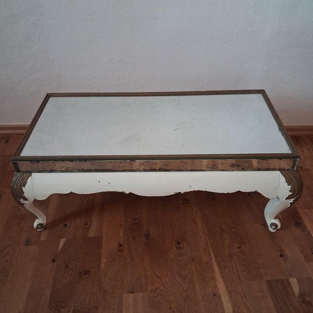 An expressive antique baroque table with an extraordinary presence. The aged mirror top, the cracked surface, and the...