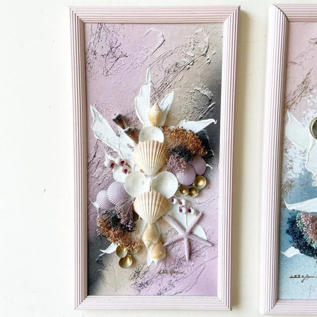 Amazing pair of framed and signed seashell art. Purple and blue painted onto the canvas.