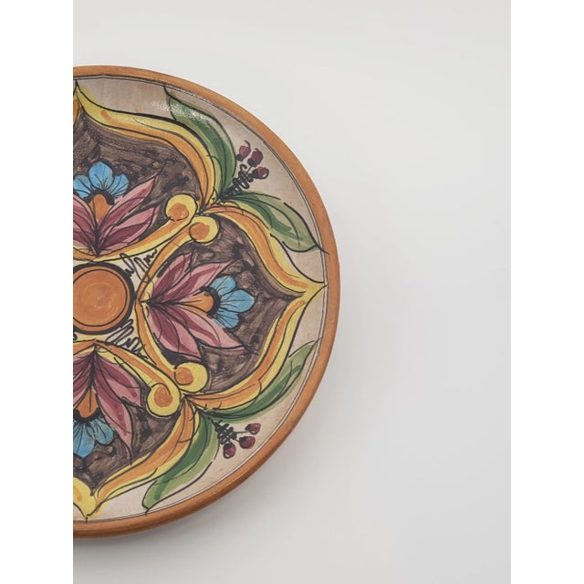 This hand-painted hanging plate is from the Italian medieval hill town of Erice (Sicily), where Majolica ceramics have...