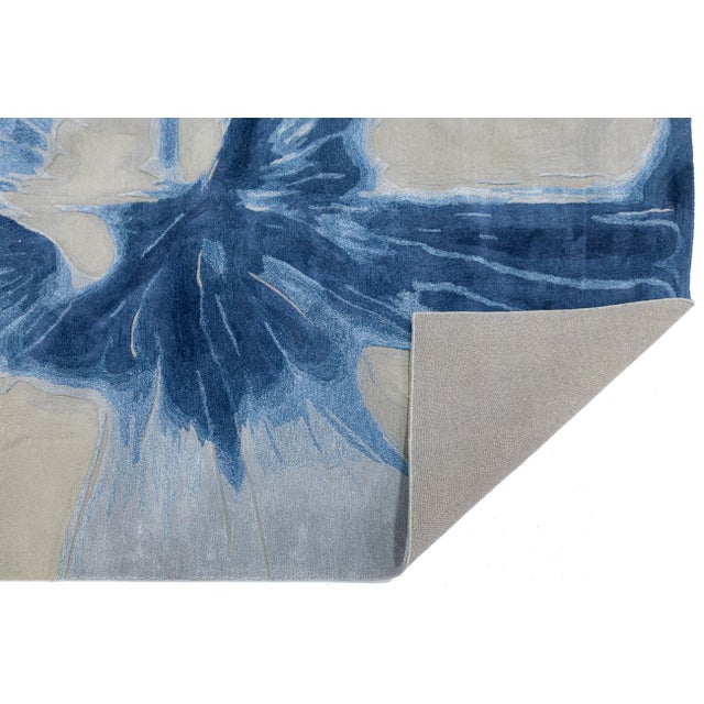 Elevate your living space with this striking hand-tufted wool and Viscose rug, featuring a dynamic, oversized abstract...
