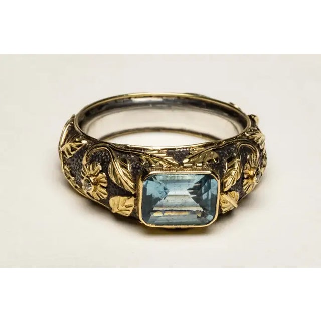 An unusual combination ring of 18K gold (weighted, not plated) over an oxidized sterling silver. It features an emerald...