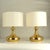 Pair of curvaceous brass table lamps, dating from the 1970s. Each lamp features a sculptural silhouette with softly...