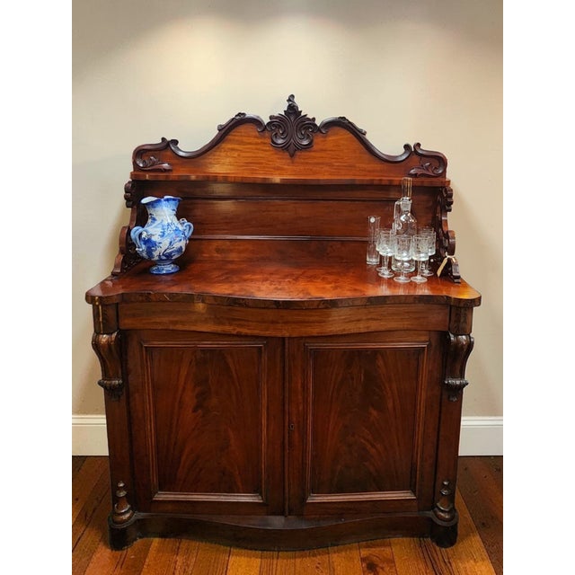 Beautifully crafted, this gorgeous and sturdy imported antique English serpentine chiffonier, circa 1840-1850, has lasted...