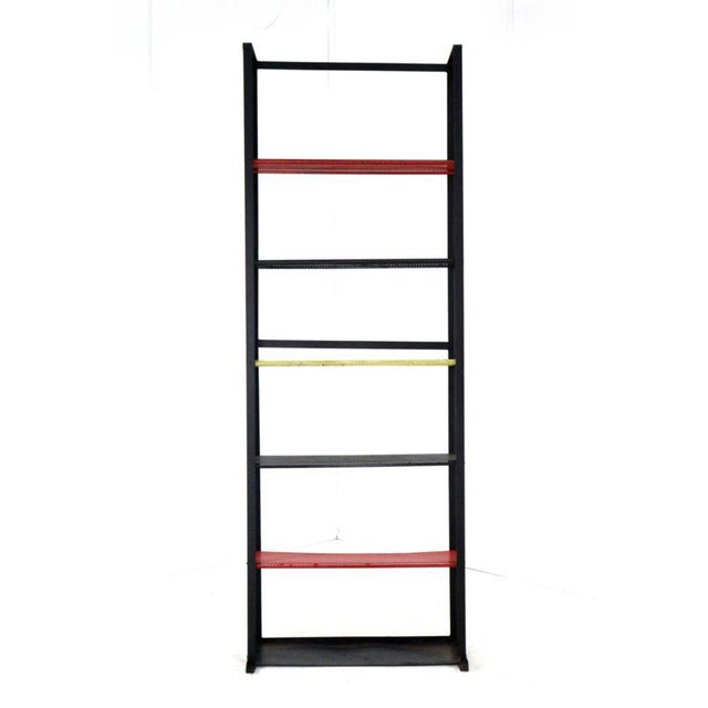 This slender, somewhat industrial cabinet is a beautiful example of functional Dutch design from the mid-century period....