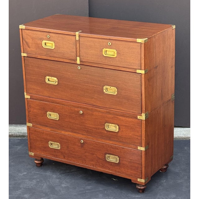 A handsome British military officer’s Campaign Ware chest of drawers or dresser, from the 19th century, featuring a...