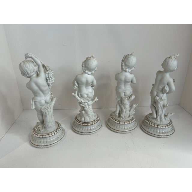 A charming set of four neoclassical putti figures inspired by classical Italian garden statuary. Each cherub is sculpted...