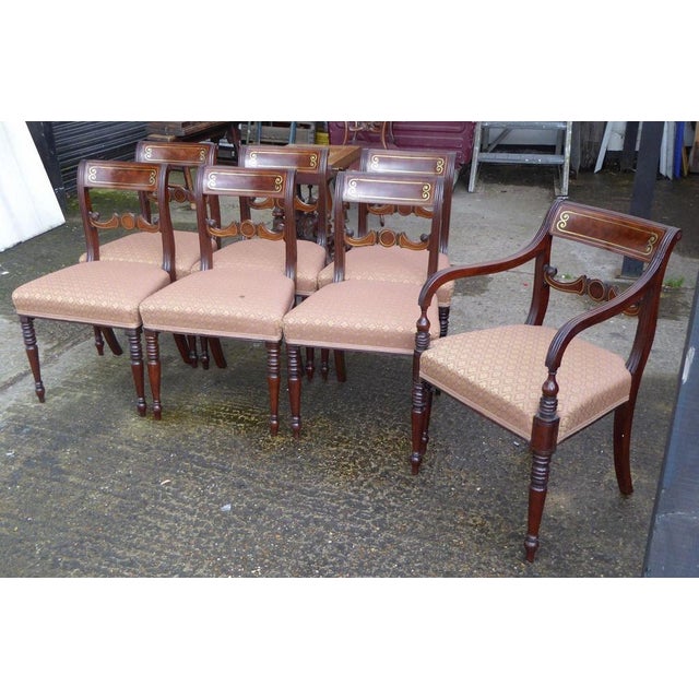 For sale is a set of 7 Regency Mahogany Brass Inlaid Dining Chairs, standing on turned legs, all in a good structurally...