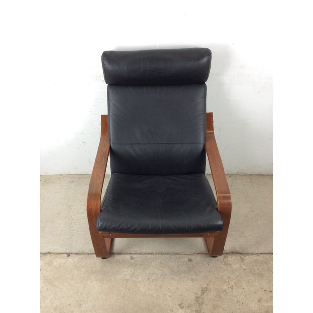 This mid century modern style lounge chair features bentwood cantilever frame, original teak finish, and removable black...