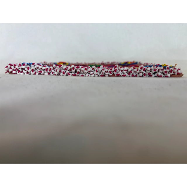 This beautiful coaster depicts a central curvy pinwheel, with a tuft of Kelly green yarn in the center. The edge is...