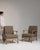 This piece presents as a pair of armchairs, distinguished by sage/olive upholstery, natural wood frame. The piece dates to...