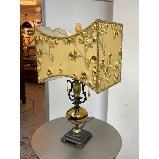 Design Plus Gallery presents a Floral Table Lamp from Pazzazed. This decorative lamp pairs a marbled art glass body with...