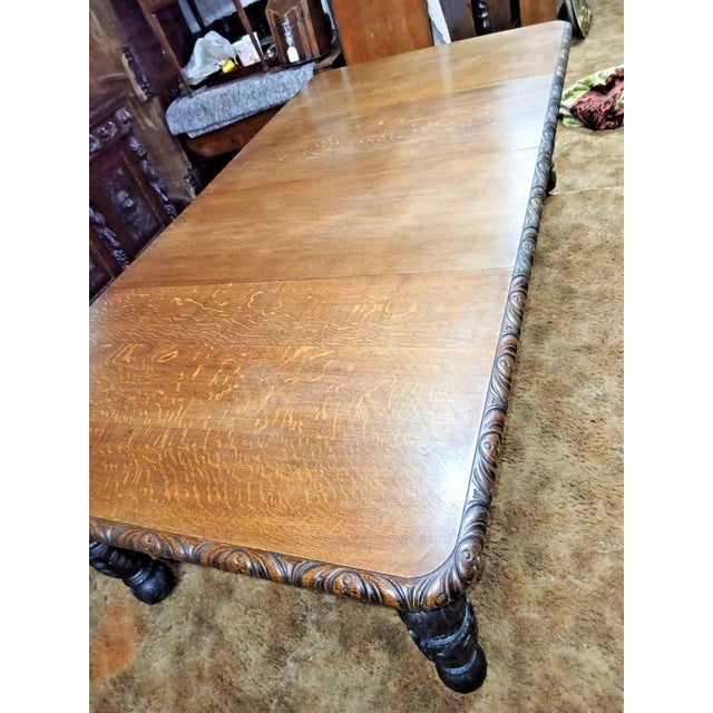 Two-Leaf Carved Oak Extending Dining Table, Seats Ten Material: Oak A substantial antique carved oak extending dining...