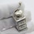 This vintage silver decorative object depicts a detailed coffee or pepper grinder miniature, crafted as a dollhouse...
