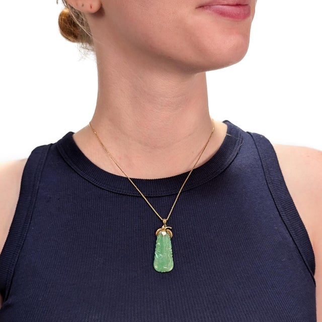 A fine antique Chinese gold & jade pendant In 14 karat yellow gold. In the form of a plum or squash. With florentine...