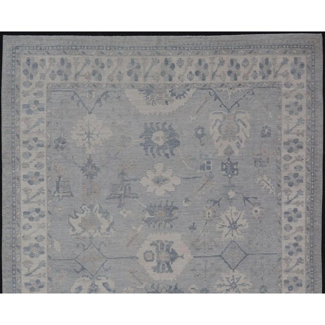 Measures: 11'3 x 14'11 Large Modern Oushak with Floral Motifs with Cream, Grey, Blue, and Powder Blue. Keivan Woven Arts;...