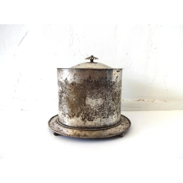 An antique silver plate (silverplate) biscuit barrel or biscuit tin, with an intricate chased floral design. Beaded base;...