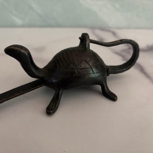 An unusual lock, circa early 20th century. Metal, likely brass, in the shape of a turtle/tortoise, and with a long key...