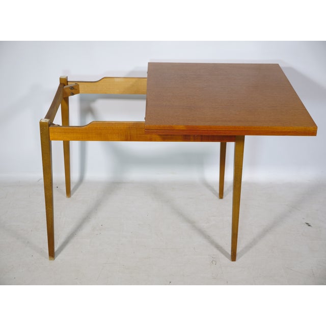 Folding dining table by Wilhelm Renz from the 1960s/70s with a warm walnut finish and a clean, minimalist design. The...