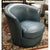 This swivel chair features smooth teal blue leather with a rounded barrel silhouette that wraps comfortably around the...