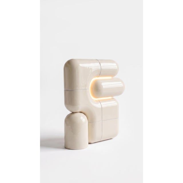 The smallest lamp in the collection, and often the first one people reach for. Its folded form hides the source entirely,...