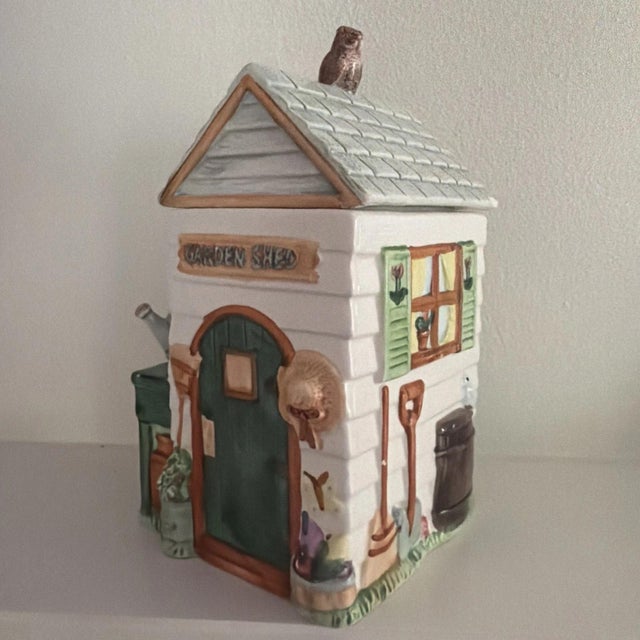 The Vintage Fitz and Floyd Garden Shed Cookie Jar is a charming addition to any kitchen or home decor. Made of ceramic and...