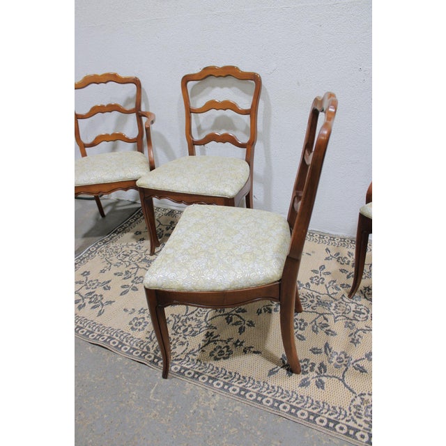Elegant set of 6 vintage cherry wood dining chairs featuring a graceful scalloped ladder-back design, warm cherry finish,...