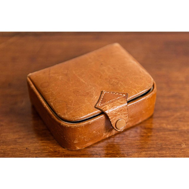 A small antique Camalier & Buckley leather case from the 20th century with buttoned strap. Founded in the 1930s in the...