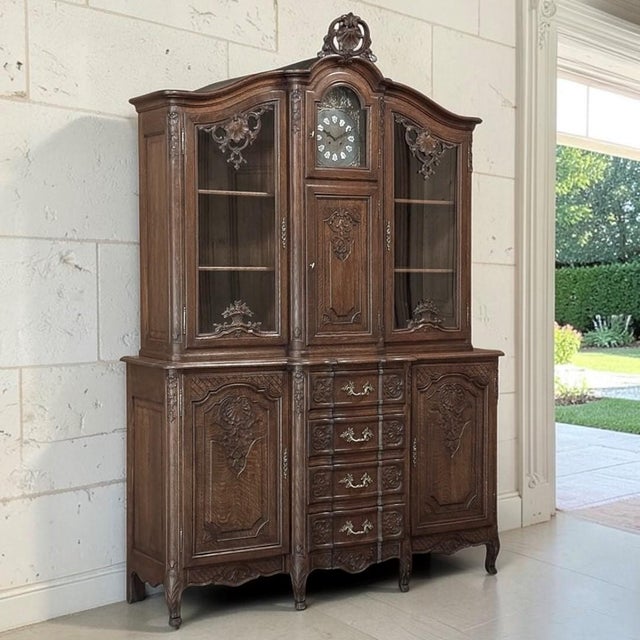 Dating to the early 1900s, this exceptional Liégeois Régence style clock buffet cabinet is crafted in solid oak and...