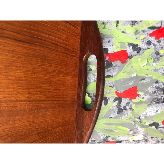 A classic and multifunctional well made tray in solid teak. Solid, ergonomic handles, easy to carry. Unsigned.