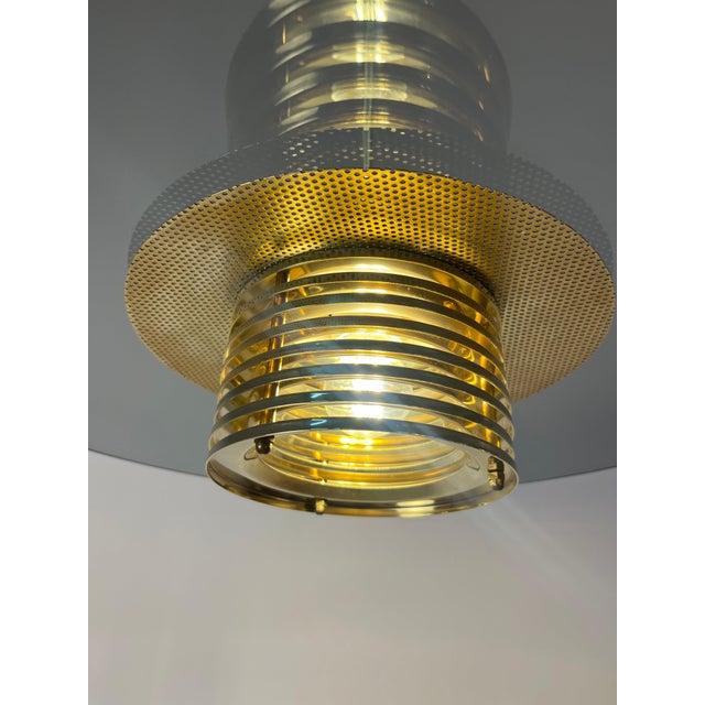 This pendant lamp, crafted from smoked glass and brass by jan eskil eskilsson for the renowned swedish manufacturer belid,...