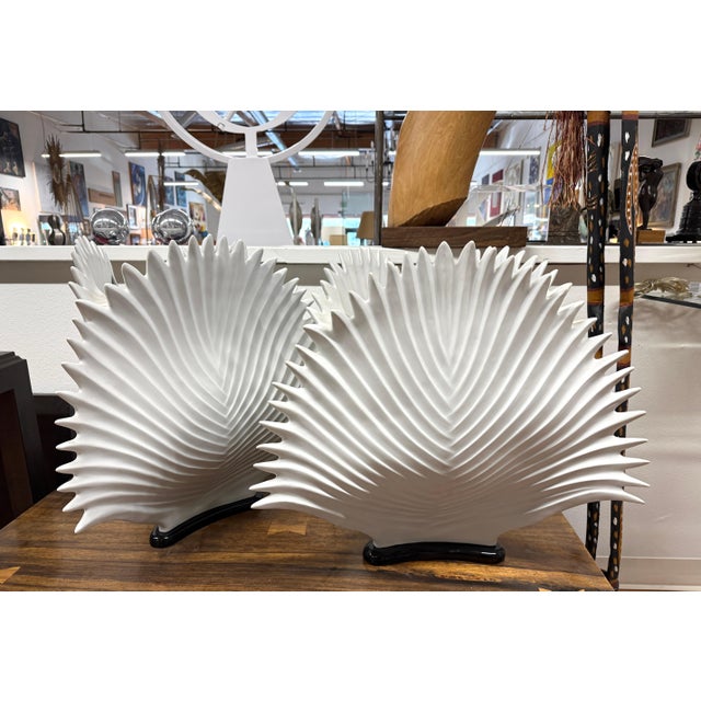 An exceptional pair of bisque porcelain lamps in a shell or fan shape. Mounted on black bases they are in working order....