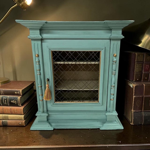 Antique tabletop French style display cabinet. Three shelves to display items is covered by a wire grid with wood frame...