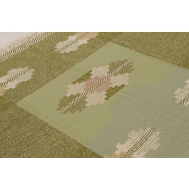 This 6x9 vintage Swedish rölakan rug is a handwoven wool and cotton flatweave by celebrated Swedish designer Ingegerd...
