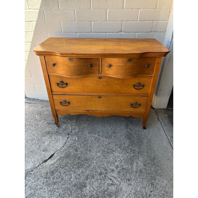 Antique serpentine front dresser / chest of drawers on casters dating from the Early 20th Century, with (2) serpentine top...