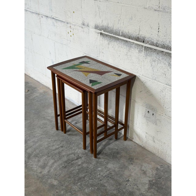 This set of three nesting tables features clean lines and geometric tile tops. Each table nests neatly to save space while...
