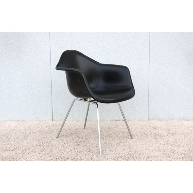 Gorgeous vintage mid-century modern Eames molded fiberglass black armchair. Arguably one of the 20th century's most...