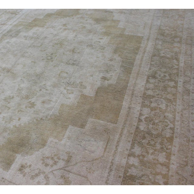Textile Medallion Design Vintage Oushak Rug in Muted Tones of Faded Yellow and Neutrals For Sale - Image 7 of 12
