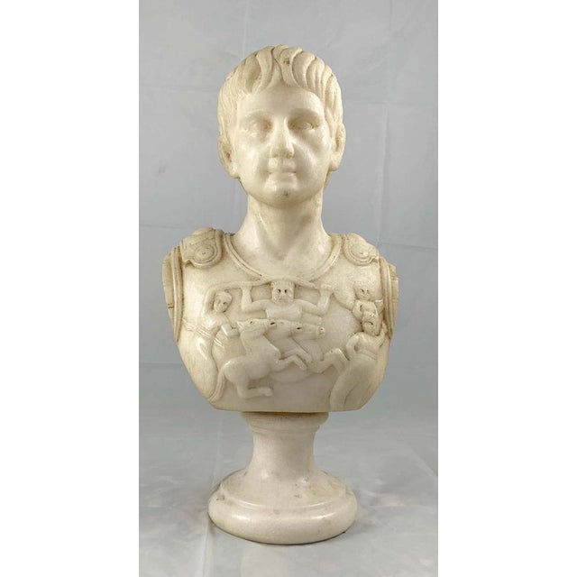 A fine white marble bust of a roman general. Finely carved with an ornate breastplate and supported on a turned socle. H...