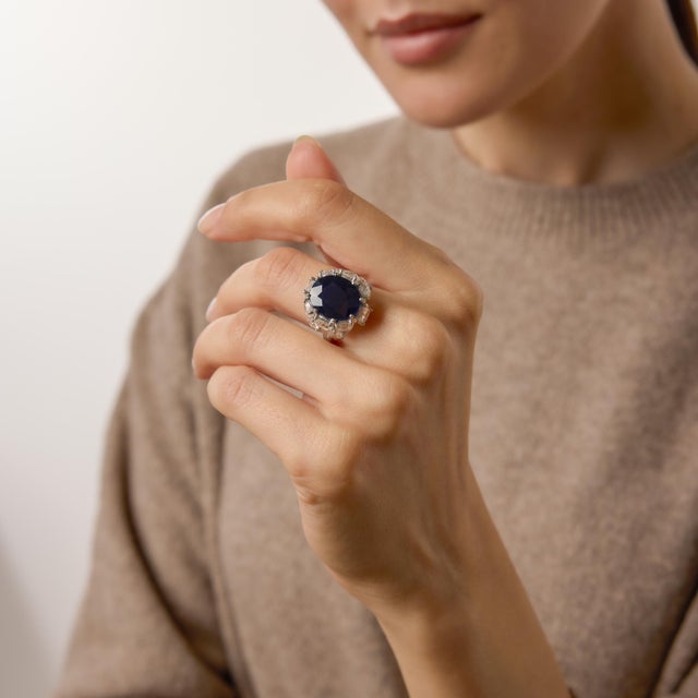 A bold and captivating statement from the 1980s, this extraordinary cocktail ring centers on an impressive 8.79 carat oval...