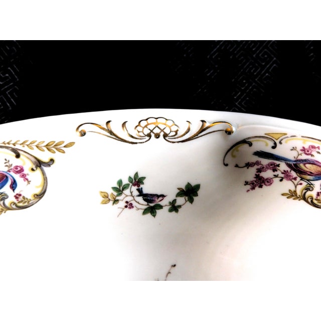 This is a ten inch oval vegetable bowl by Royal Bayreuth in pattern ROB91. The bowl is an ivory color with a pink and blue...