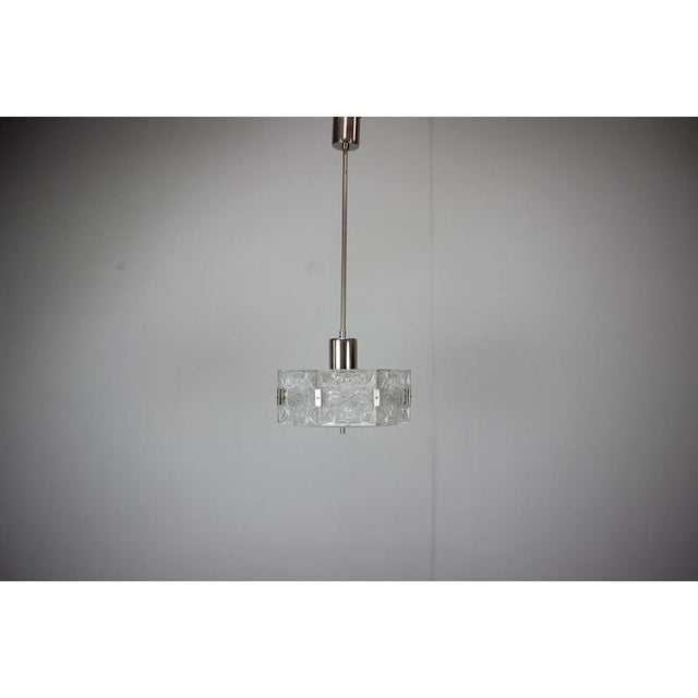 Elegant pendant light produced in Kamenický Šenov, Czechoslovakia during the 1970s. This sophisticated Mid-Century Modern...