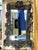 An ornate, palatial-sized Rococò style rectangular beveled glass wall mirror in a dark, aged wood finish with a heavily...