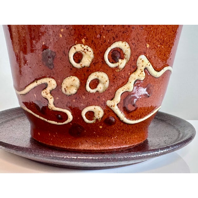 A high-quality studio ceramic art cup with saucer, created by the renown German ceramic artist Helma Klett (1908-1996)...