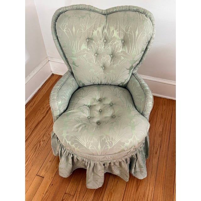 A petite 1940s ladies chair in a light sage green damask upholstery. Finished with a pretty ruffled skirt. A very Dorothy...