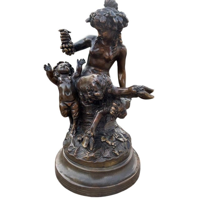 A beautiful bronze sculpture depicting a woman offering a bunch of grapes to a child. This sculpture was cast using the...