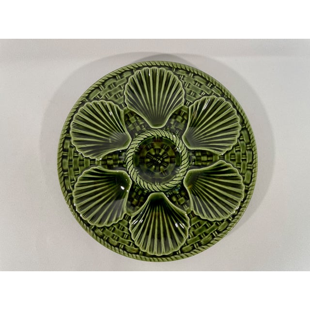 A beautiful French Majolica Longchamp glazed oyster plate in a vibrant emerald green color from circa early 1920s. The...