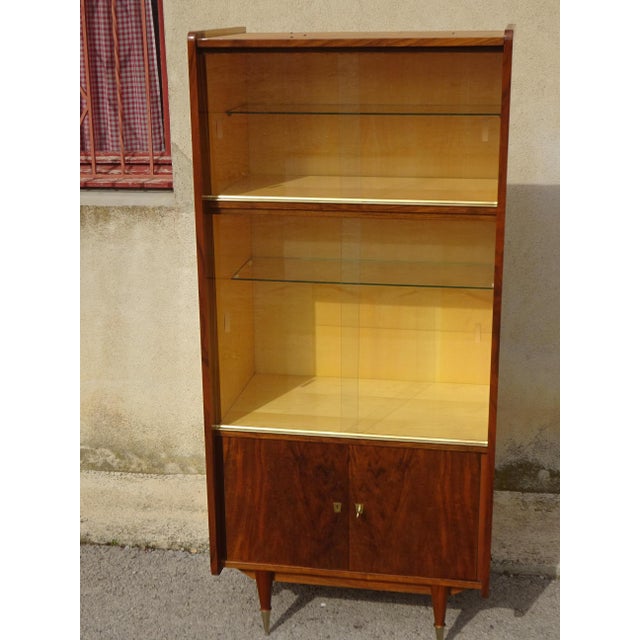 A high-quality display cabinet from the 1950s, made by Maison Capelle in Montauban (82), France. The cabinet is crafted...
