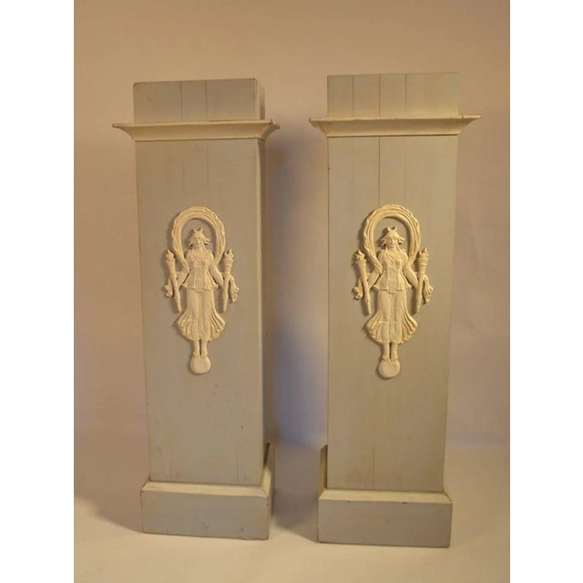 Contemporary pair of Decorative French Pedestals with carved Indochine figures holding torches.